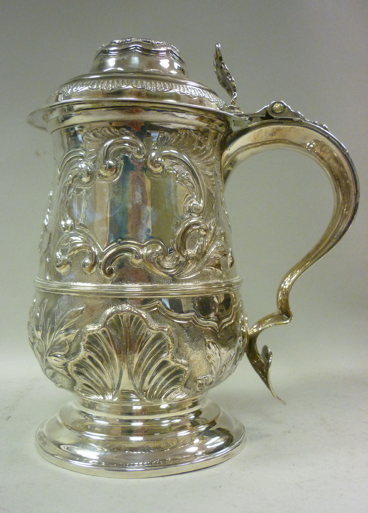 A George III silver tankard of baluster form, having a hollow double C-scrolled handle and heart