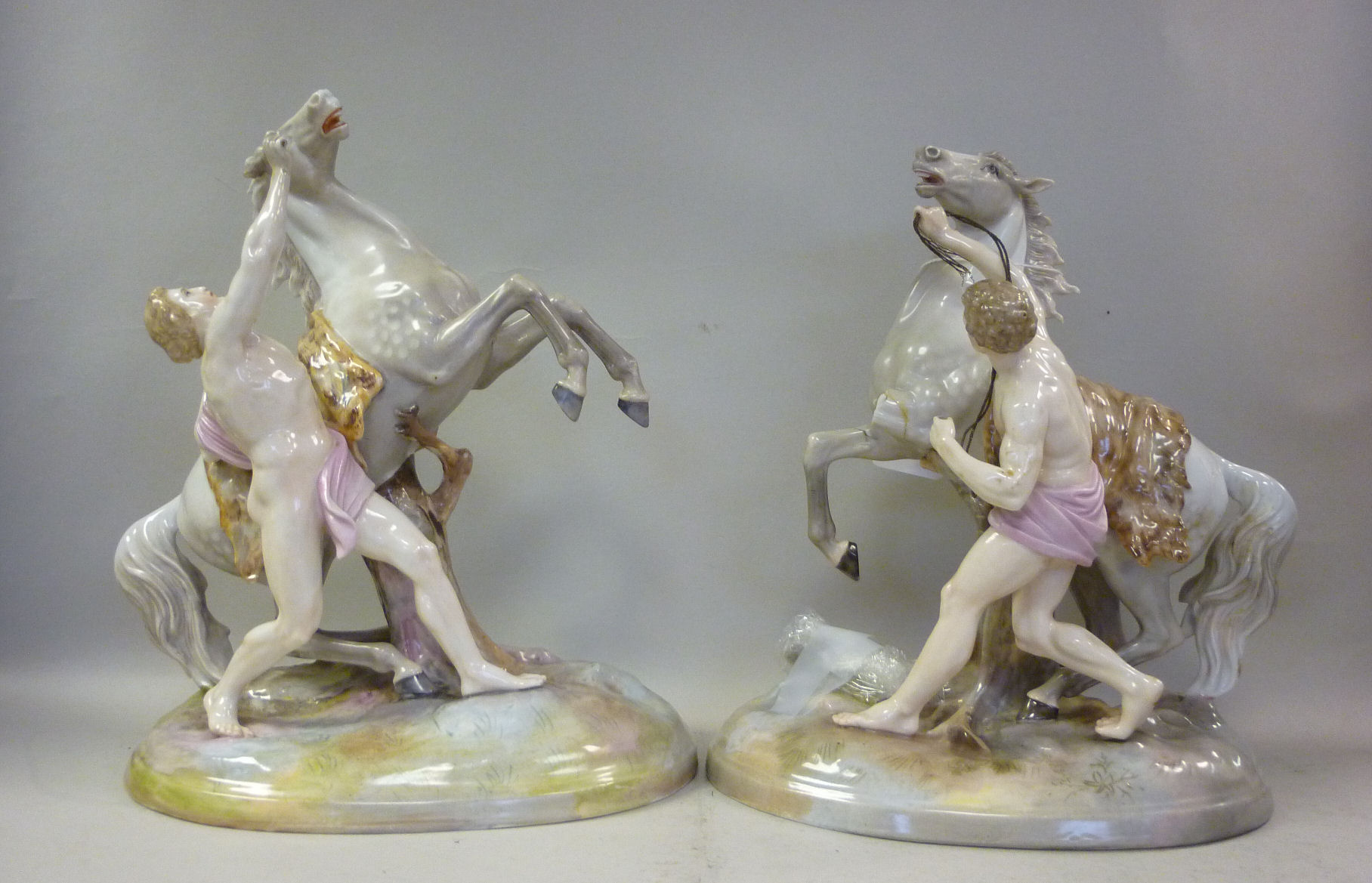A pair of late 19thC Continental porcelain Marli inspired models, horses with attendants 9.5``h