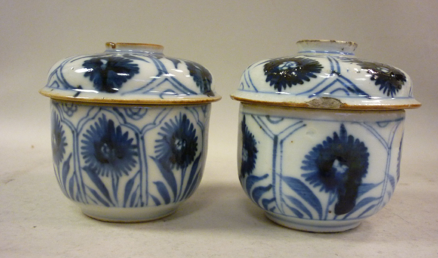 A pair of mid 18thC Chinese Kangxi porcelain covered pots, decorated in blue and white with