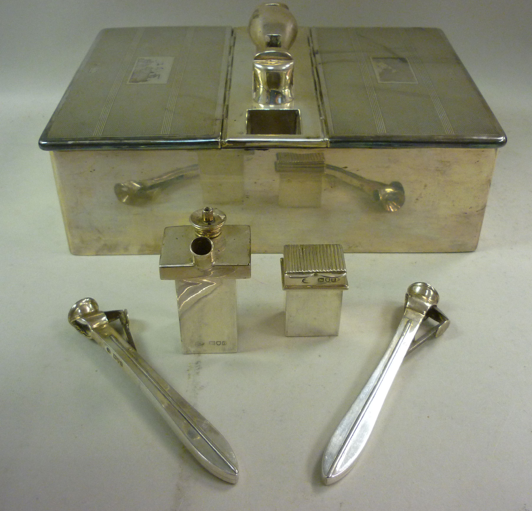 A late Victorian silver cigar smoker`s compendium with engine turned decoration, the rectangular box