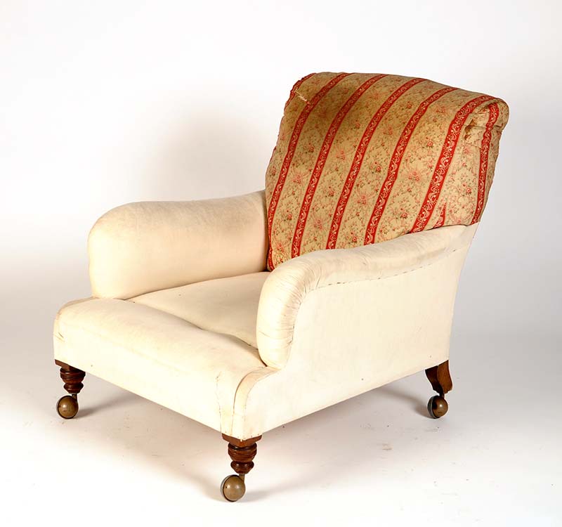 †  A late Victorian easy chair, by Howard & Sons Ltd., Burners Street, London, with loose covers