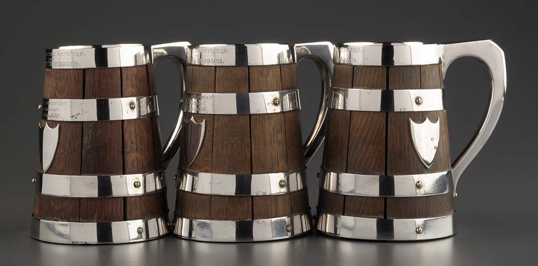 Three coopered oak barrel-pattern tankards, by John Grinsell & Sons, with electroplated bands,