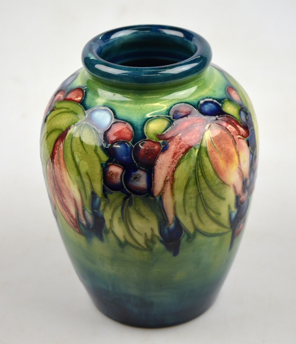 A Moorcroft ovoid vase decorated with grape and leaf design on a variegated green ground, 16 cm,