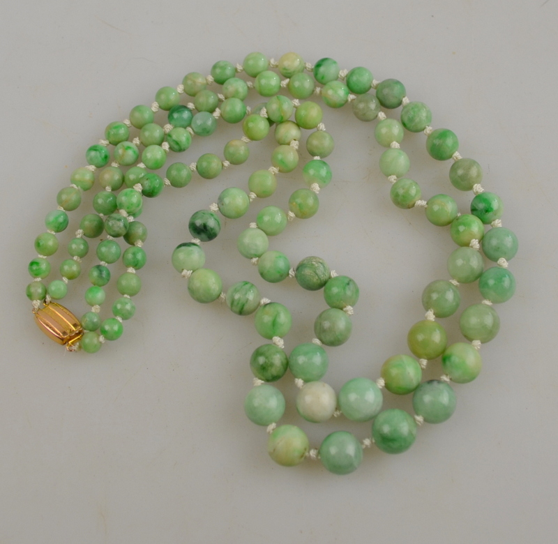 Two-row graduated jade bead necklace of mixed green colours on yellow gold snap stamped 9ct