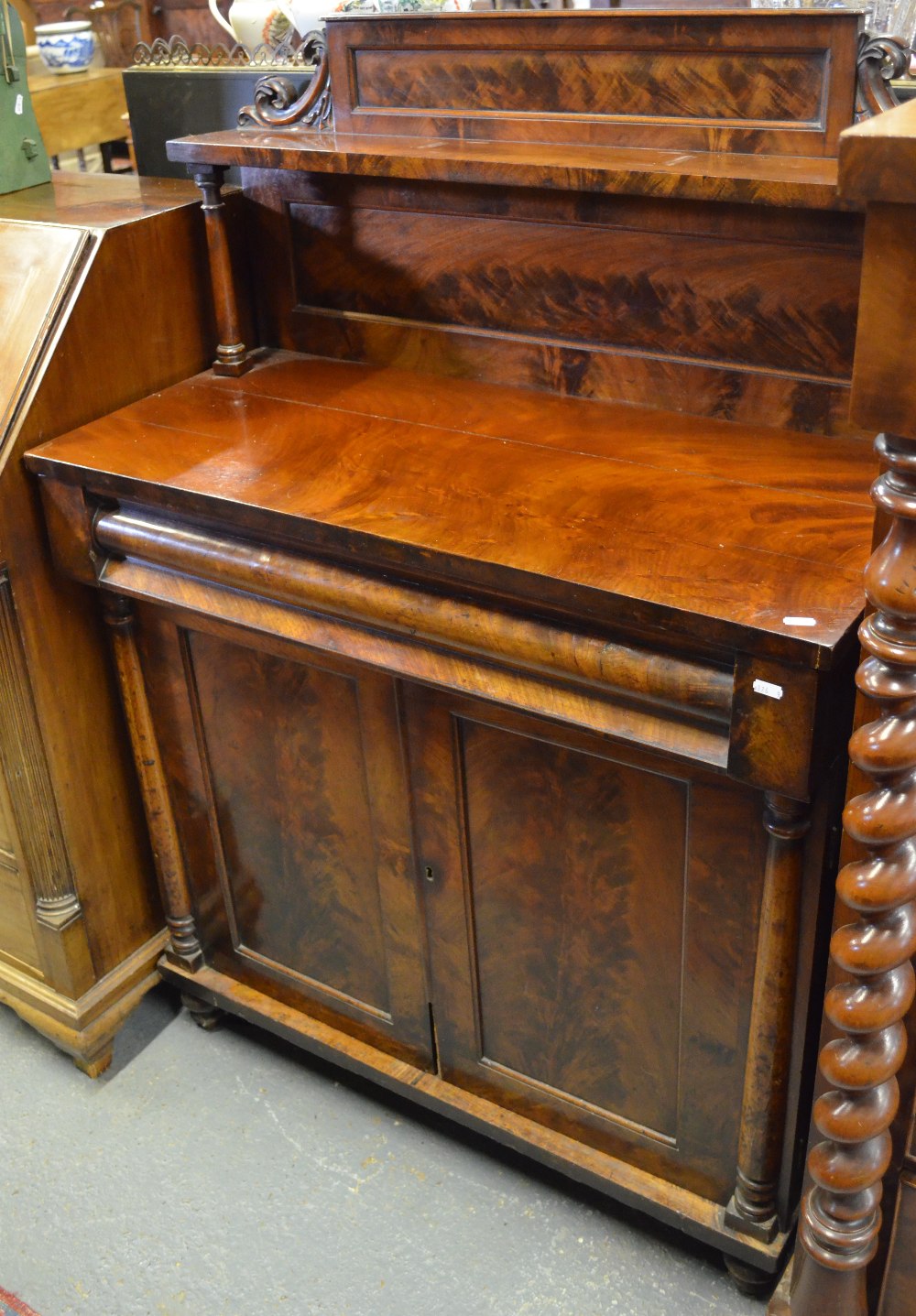 Victorian mahogany chiffonier, the carved back over a frieze drawer and pair of panelled doors