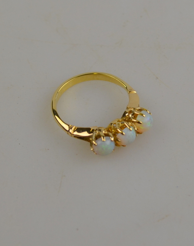 Three-stone cabochon opal ring in yellow gold claw setting stamped 18ct, size N 1/2 Condition Report