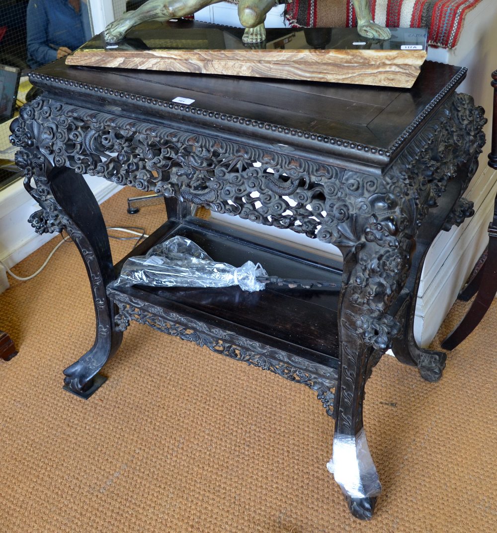 A 19th century Chinese carved rosewood centre table/stand, heavily carved with dragons and leaf