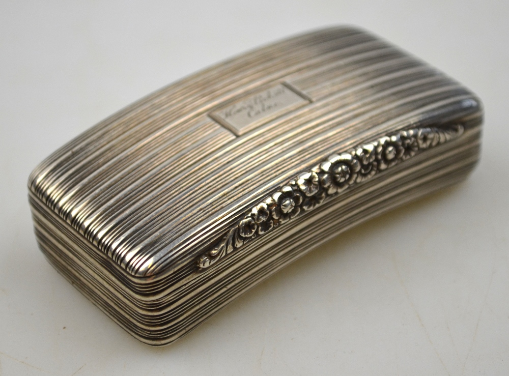 A George III silver snuff box with reeded decoration and ornate floral thumb-piece, gilt interior,