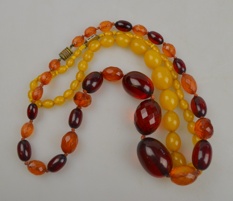 Two rows of beads, one yellow, one red, with some facetted beads in between (a/f)