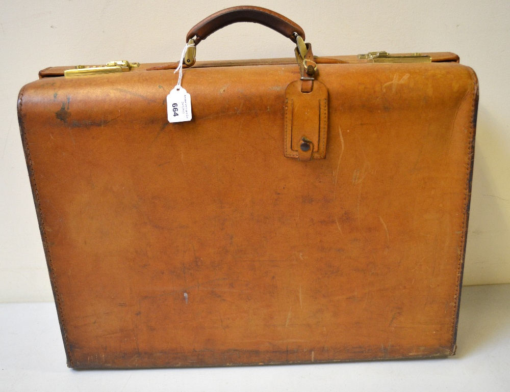 A tan leather attache/briefcase with fitted interior and gilt metal fittings retailed by Schulz of