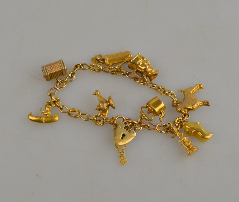 9ct yellow gold fancy linked bracelet with padlock and safety chain and nine various charms