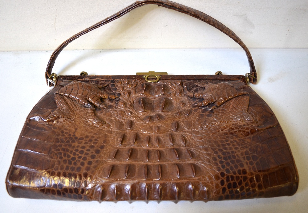 Dark brown crocodile handbag with feet embellishment to front and gilt metal fittings