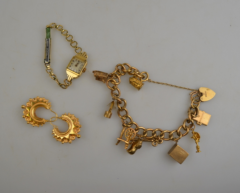 9ct yellow gold curb bracelet with padlock and safety chain having nine various charms attached,