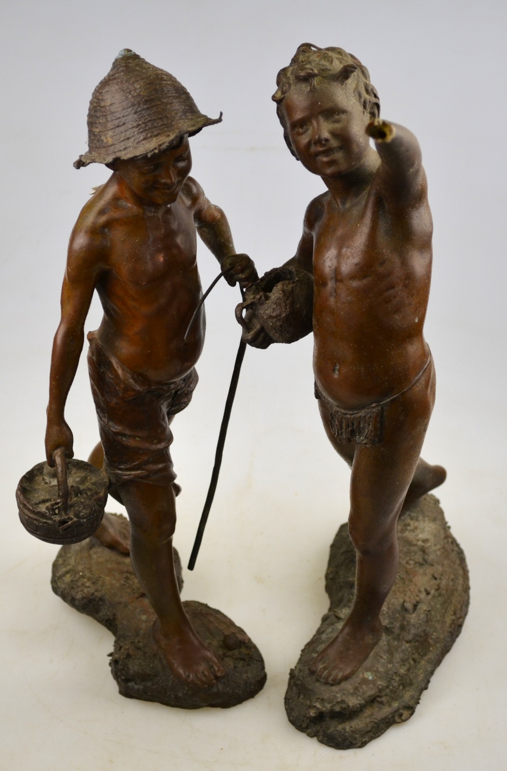 A pair of brown patinated bronze figures - a young boy shell collector with bucket and stick, the