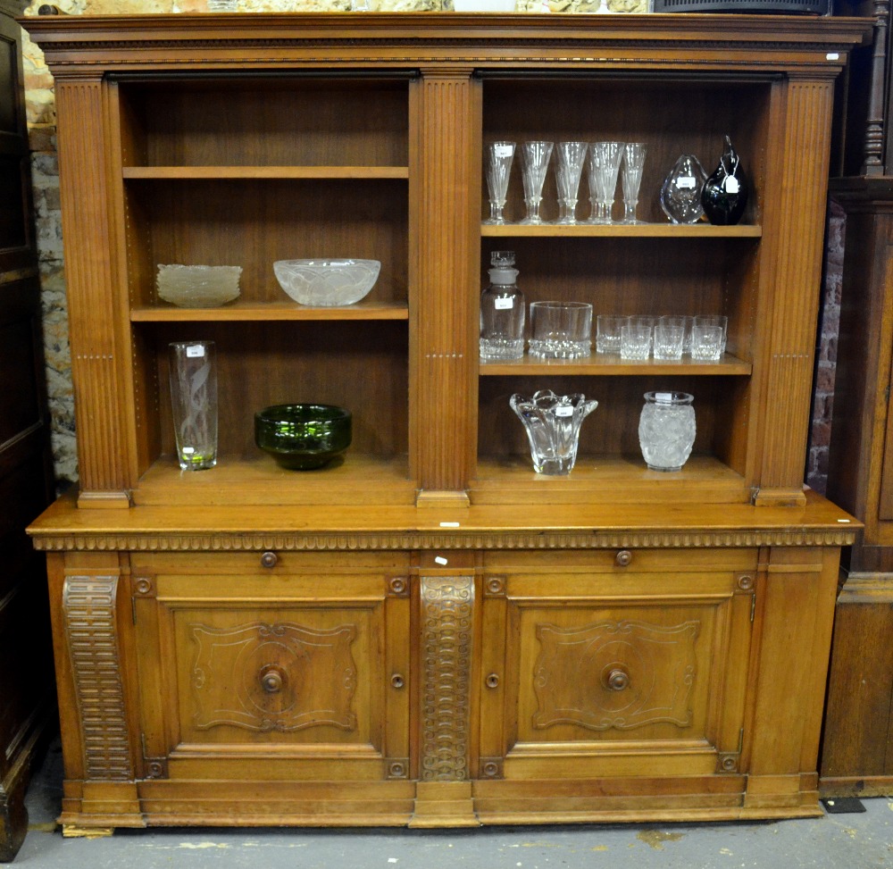 A Continental oak library bookcase of diminutive proportions, the canopy top with egg and dart