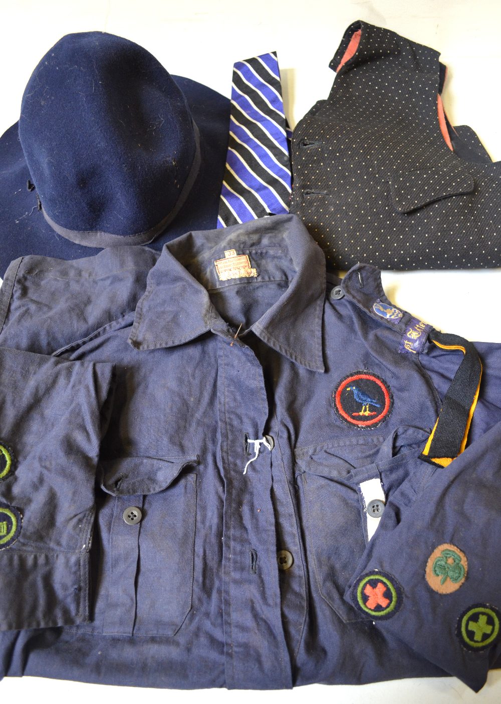 Early Girl Guide uniform and hat, school tie and a spotted waistcoat