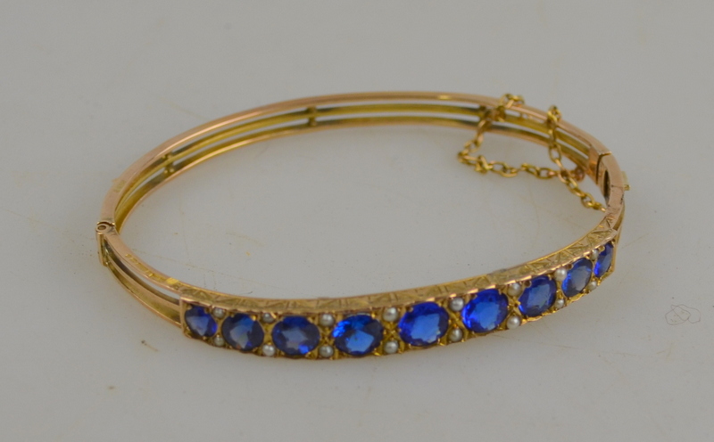 Blue paste and half pearl bangle, yellow gold set, in fitted box, snap stamped 9ct Condition