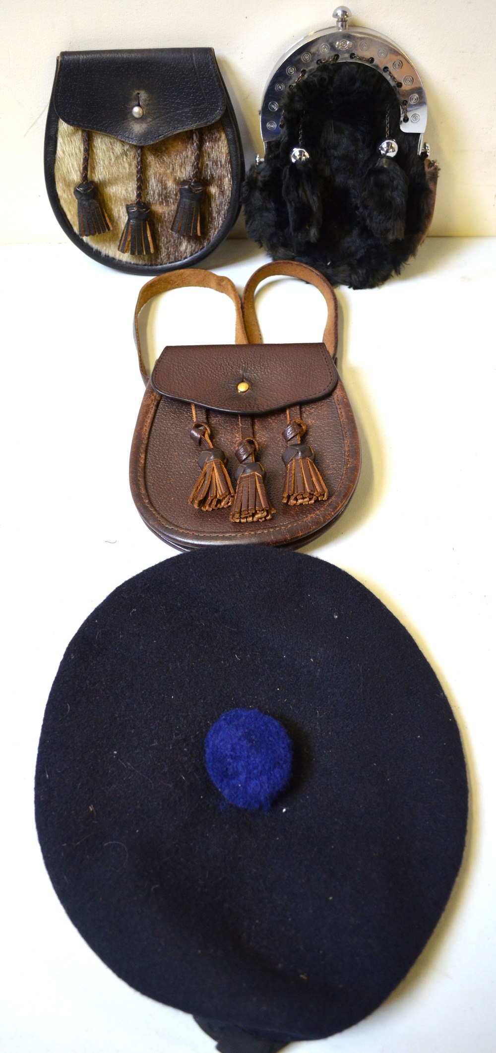 Leather and seal-skin sporran with three tassels, leather three-tasseled sporran and a moleskin