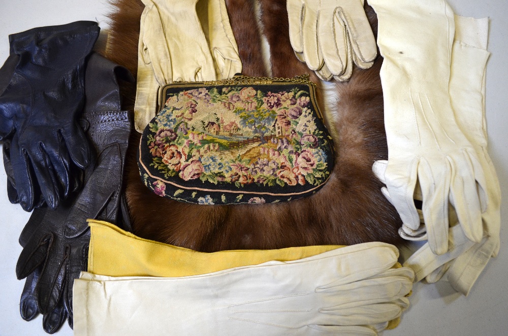 Two pairs of white and one pair of yellow kid leather gloves, a mink fur collar and a smaller fur