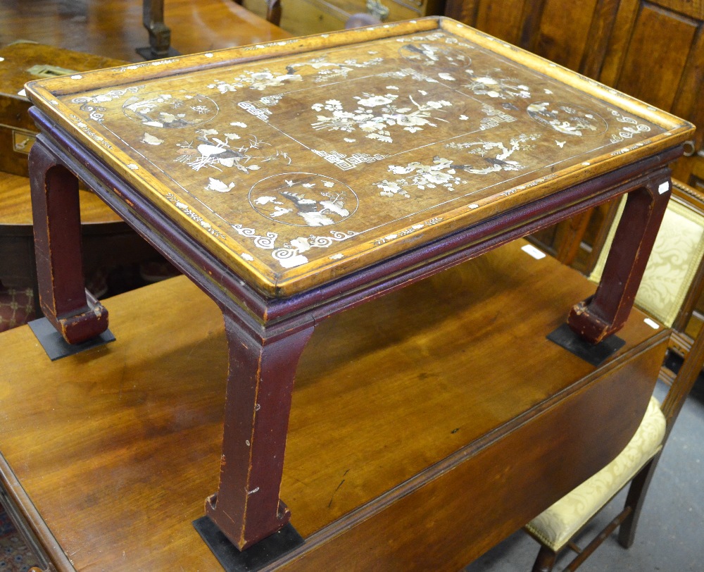 A late 19th century Chinese mother-of-pearl inlaid hardwood tray-top table, raised on a red