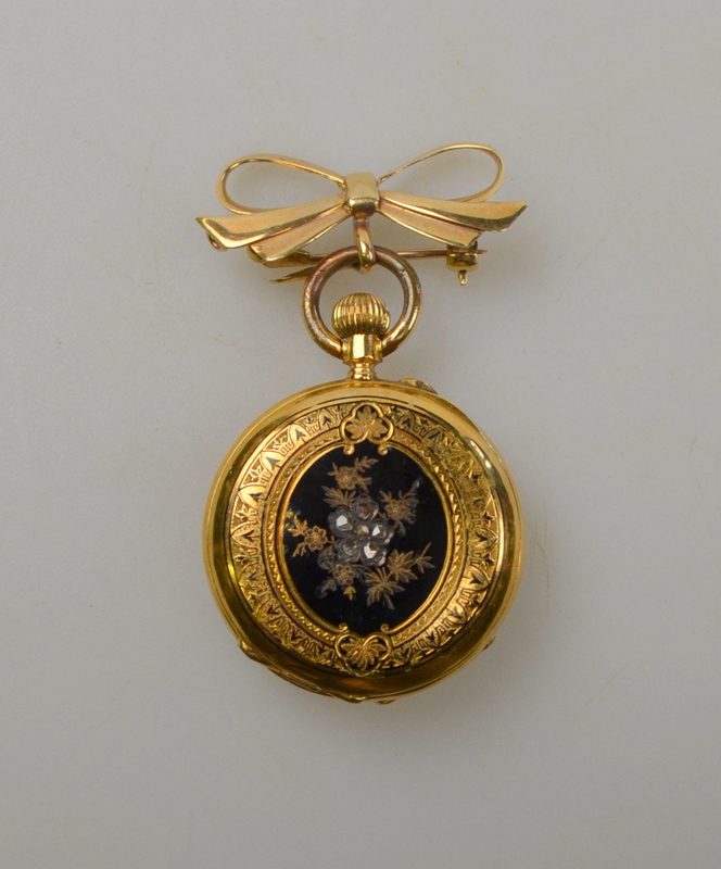 18k yellow gold fob watch button wind having white enamel dial with Roman numerals, back of case set