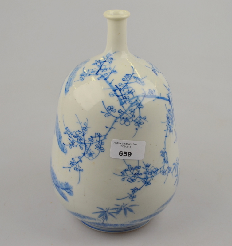 A Japanese blue and white porcelain gourd-shaped bottle vase with narrow neck, painted with prunus