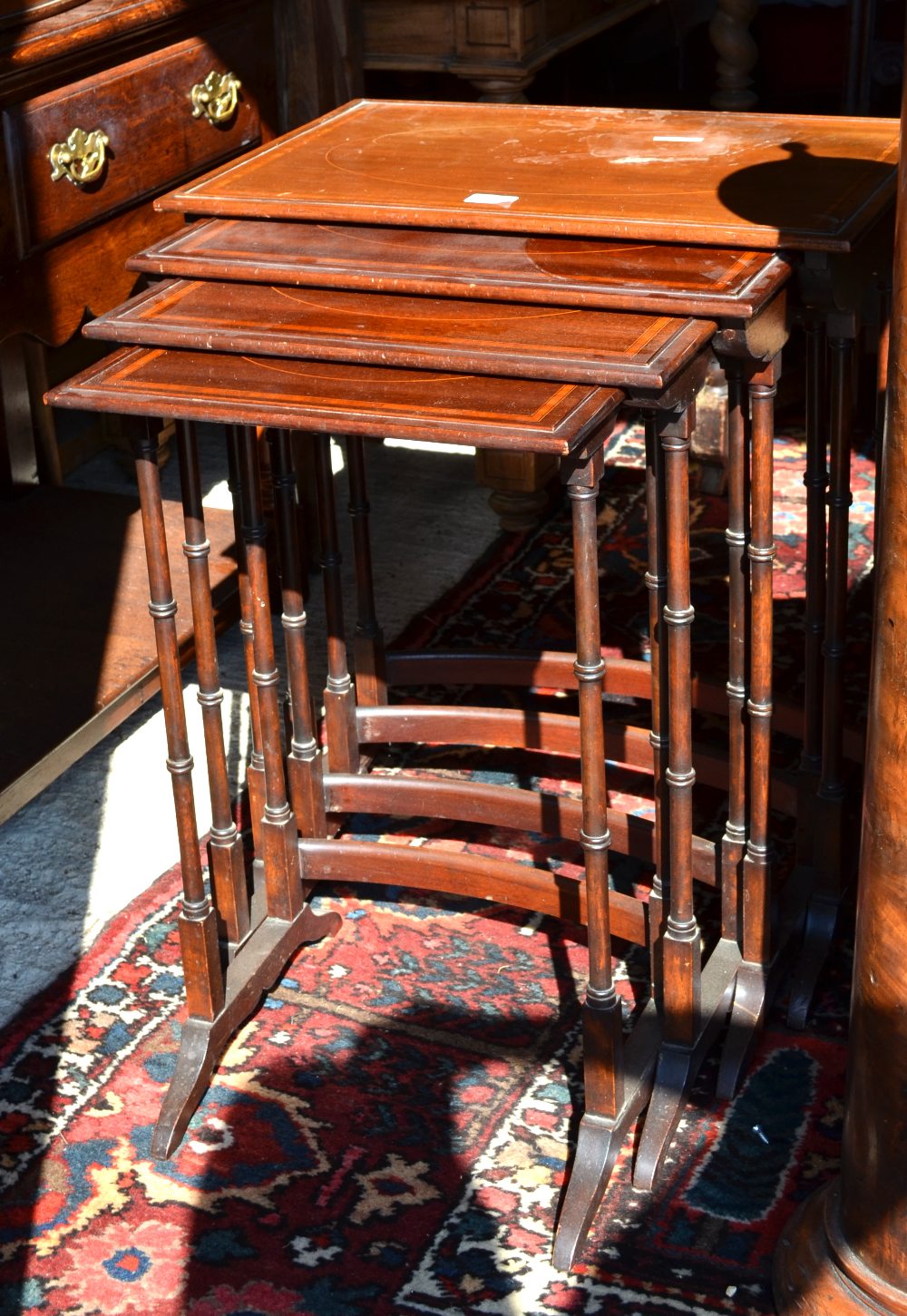 A 19th century satinwood crossbanded mahogany nest of quartetto tables, the rectangular tops