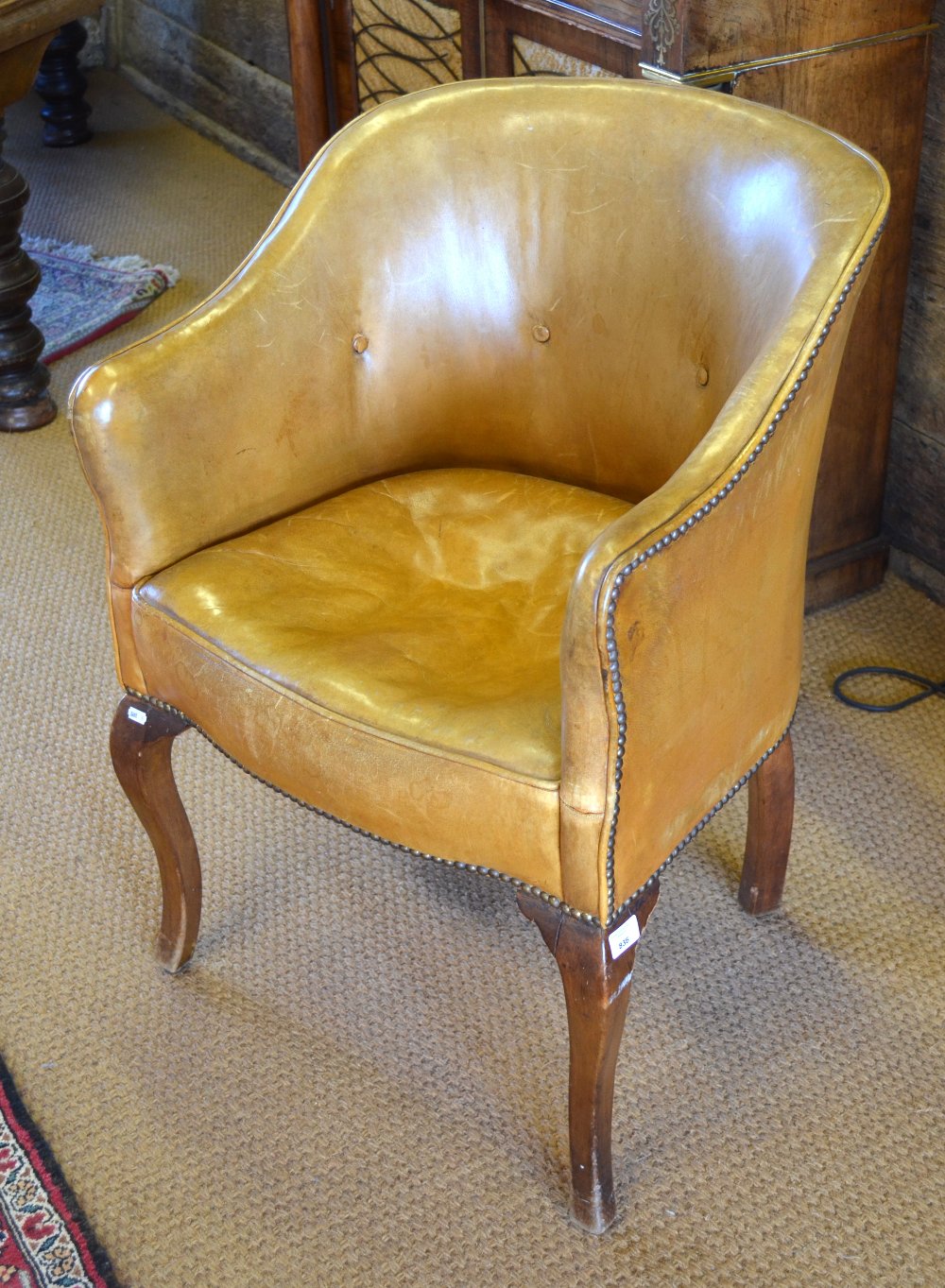 A 19th century studded tan leather library chair, raised on club front legs Condition Report Leather