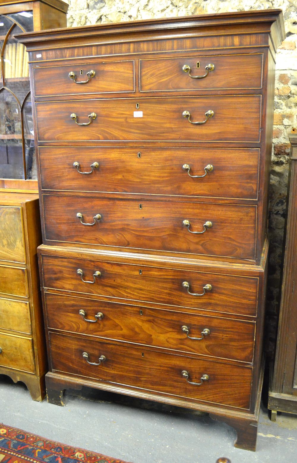 A George III mahogany chest on chest of two short over six long graduated drawers retaining original