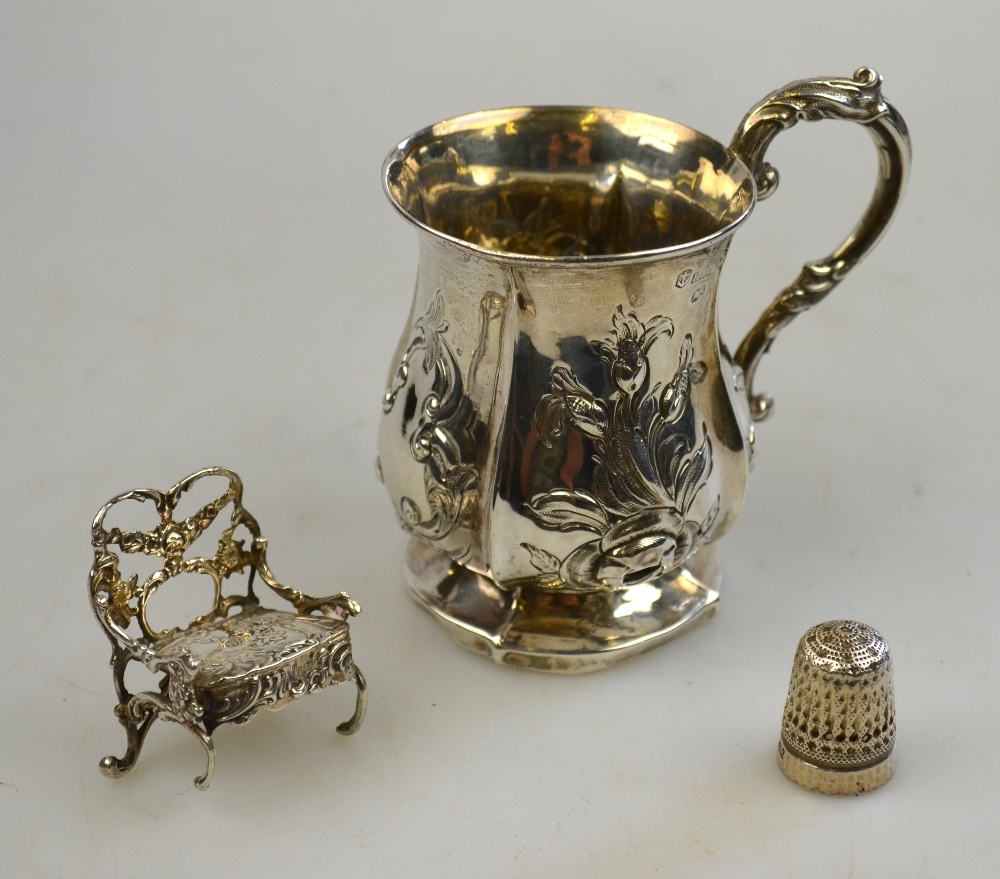 A small Victorian silver baluster Christening mug with scroll handle, embossed and chased decoration