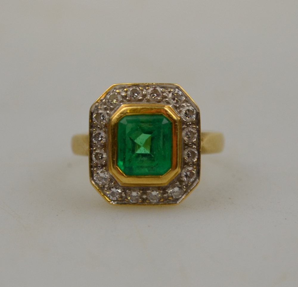 Rectangular emerald and diamond cluster ring, the step cut emerald in cluster setting, with