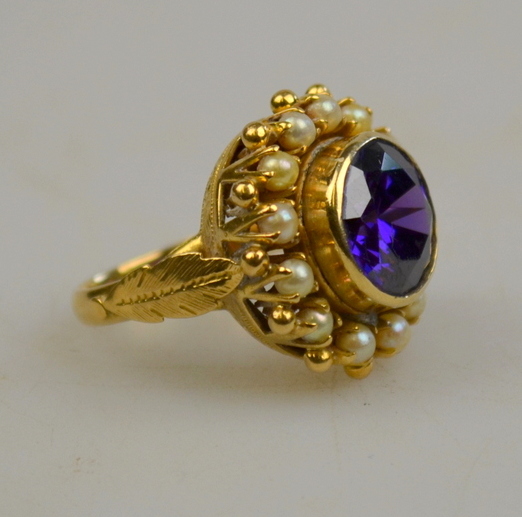 Purple stone and pearl cluster ring in coronet yellow metal setting, size L 1/2 Condition Report