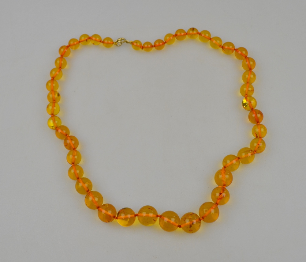 A single row of clear graduated amber beads showing natural inclusions Condition Report weight 36.