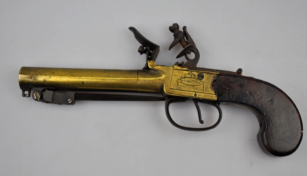 An early 19th century flintlock pistol by Wheeler, London, the 10 cm brass turn-off barrel fitted