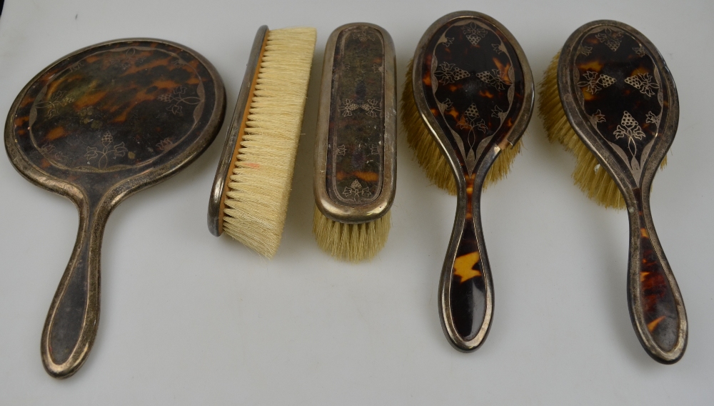 A silver and tortoiseshell five-piece brush set (a/f)