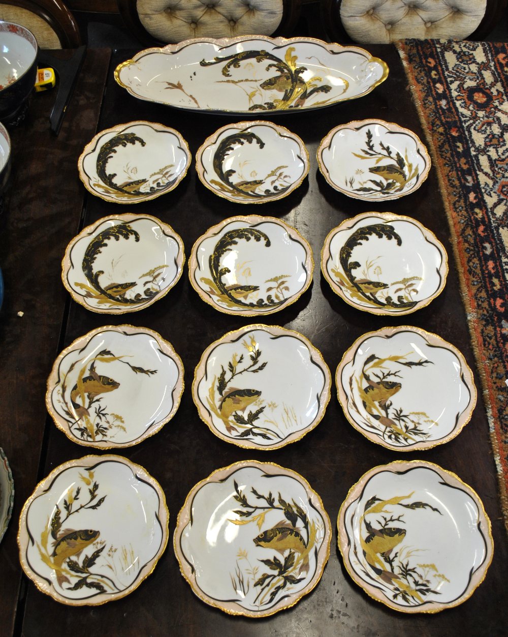 S & S Limoges porcelain fish service decorated in the Japanese style with a fish in reeds,