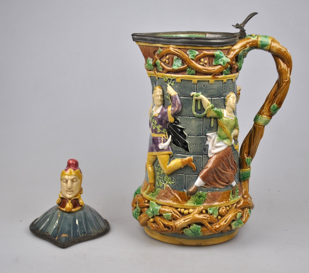 A Victorian Minton majolica tower jug relief moulded with medieval dancers, the pewter edged lid