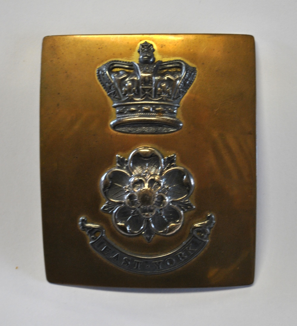 A brass polished steel East York Regt. chest plate, 9 cm x 8 cm