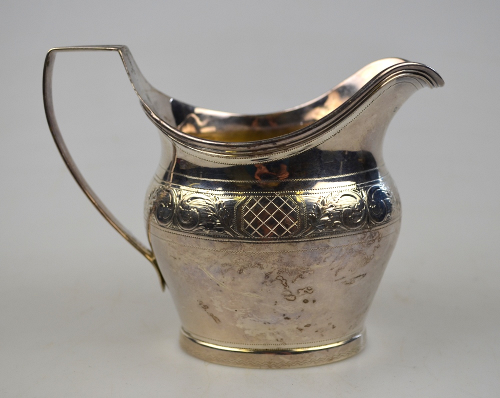 A George III silver helmet cream jug with reeded rim and handle and engraved band, Robert & Samuel