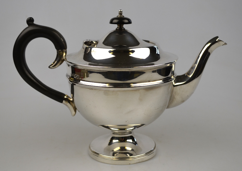 A silver teapot on circular stemmed foot, Viners Ltd., Sheffield 1932, 17 oz gross