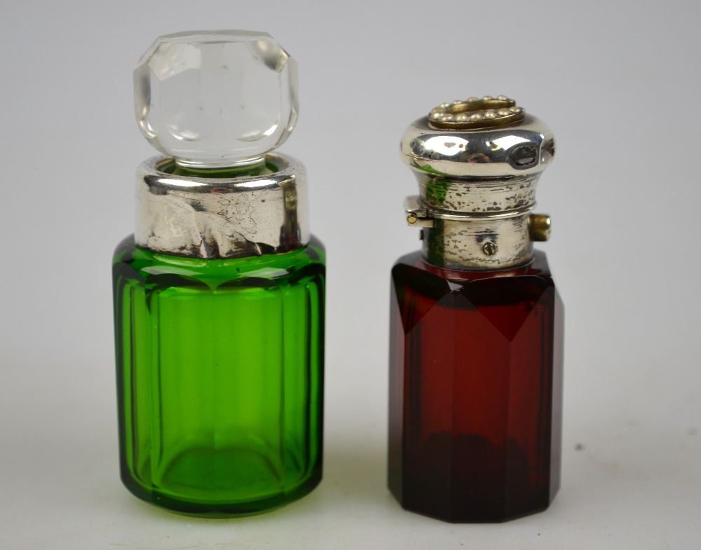 A ruby glass scent bottle, the hinged bun cover set with a seed-pearl horseshoe, to/w a green