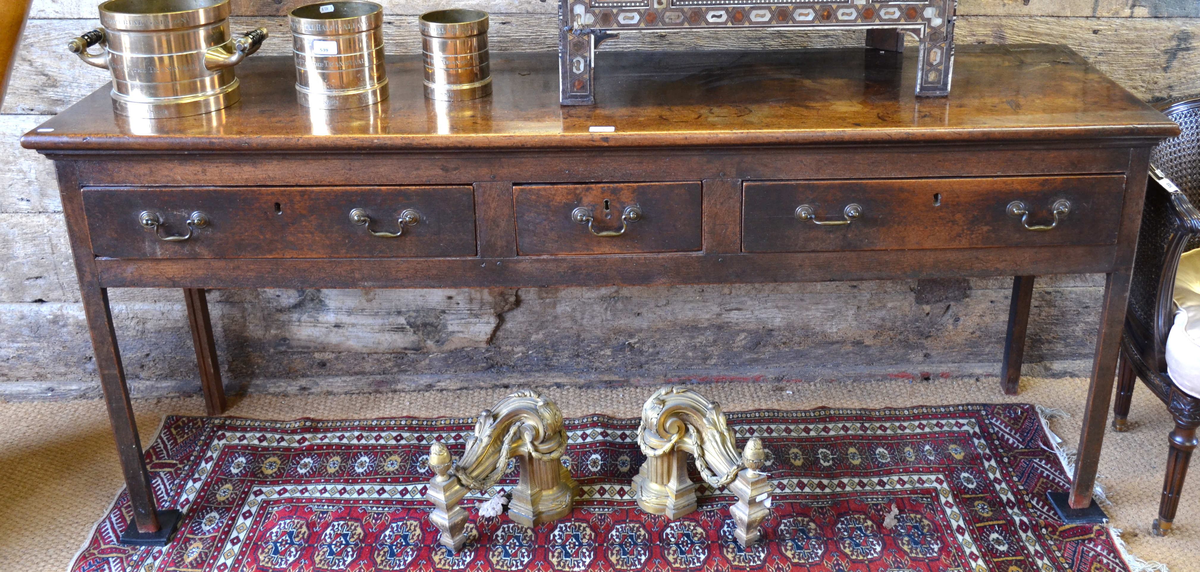 An 18th century oak three drawer base, the wide plank top over two long drawers flanking a short