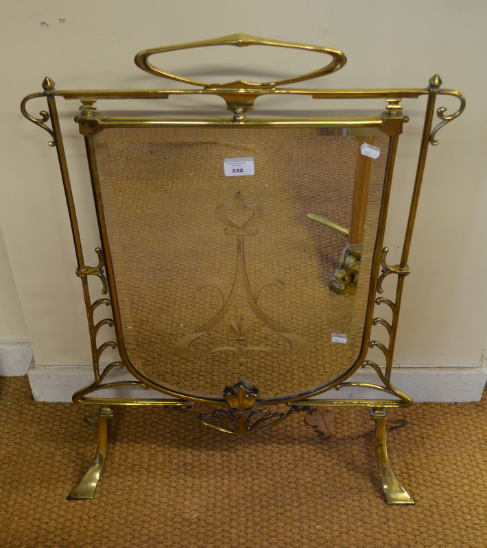 A brass framed mirror panelled Art Nouveau fire screen