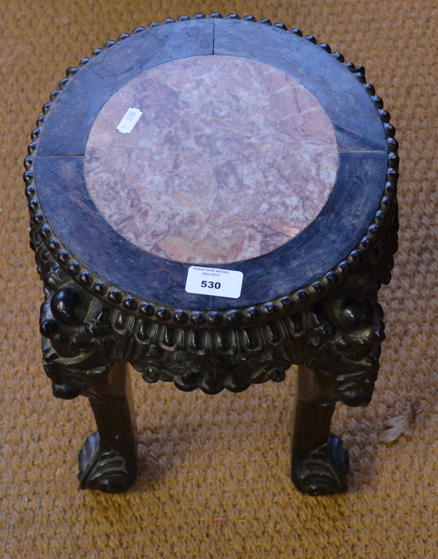 A late 19th century Chinese ebonised rosewood table, on circular form, the top centred with a veined