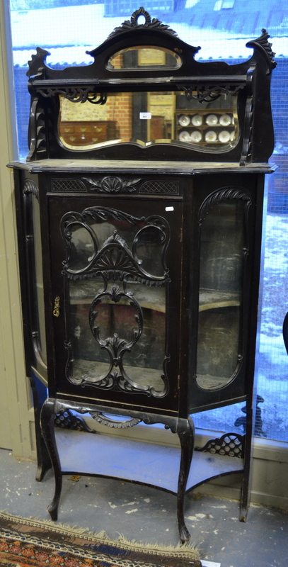 A late 19th century ebonized mirror backed glazed display cabinet, with velvet lined interior over