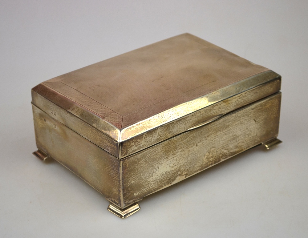 An engine-turned silver cigar box with cedar lining (marks worn), 18.5 x 13 cm Condition Report