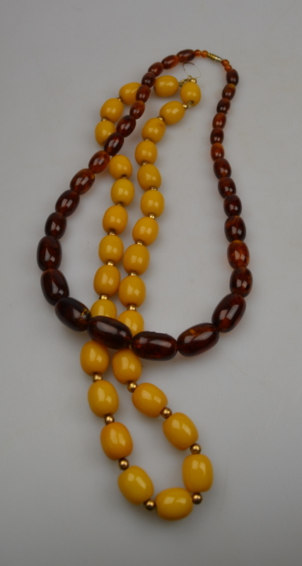 Single row of large yellow and gilt metal beads to/w simulated amber beads (2)