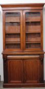 A Victorian mahogany bookcase, the moulded cornice above a pair of glazed doors, the base with a