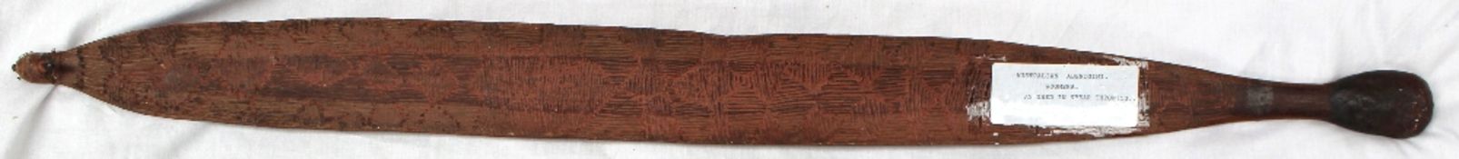 An Aboriginal Woomera spear thrower decorated with geometric line decoration, 87 cm long