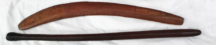 An Aboriginal Boomerang, of usual form, 61 cm long together with an Aboriginal nulla nulla weapon,